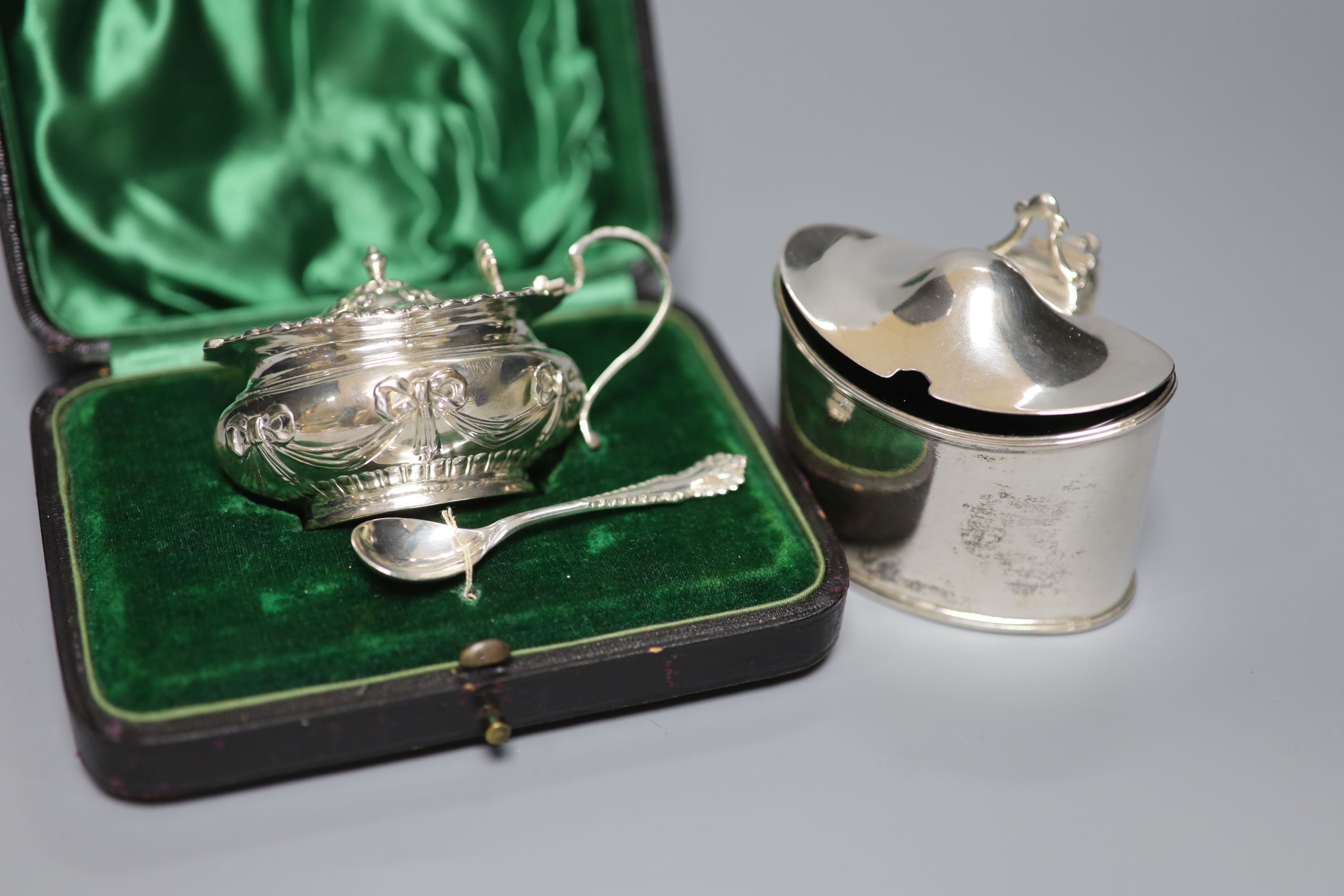 Four mustard pots, various, including a George III oval silver mustard, London 1789, Henry Chawner